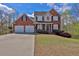 Traditional brick home with two-car garage and well manicured lawn at 705 Sunset Ridge Se Ln, Lawrenceville, GA 30045