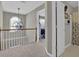 Hallway features stylish chandelier, railing and an open doorway at 705 Sunset Ridge Se Ln, Lawrenceville, GA 30045