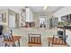 Open-concept kitchen with granite countertops, white cabinets, stainless steel appliances, and breakfast bar seating at 705 Sunset Ridge Se Ln, Lawrenceville, GA 30045