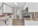 Bright kitchen boasts white cabinetry, stainless steel appliances, and granite countertops at 705 Sunset Ridge Se Ln, Lawrenceville, GA 30045