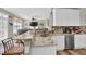 Open-concept kitchen with granite countertops, stainless steel appliances, and breakfast bar seating at 705 Sunset Ridge Se Ln, Lawrenceville, GA 30045