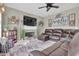 Cozy living room featuring a fireplace, a large sectional sofa, and modern décor at 705 Sunset Ridge Se Ln, Lawrenceville, GA 30045