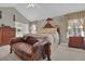 Comfortable main bedroom with decorative canopy bed, sitting area, and ornate furniture at 705 Sunset Ridge Se Ln, Lawrenceville, GA 30045