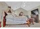 Spacious main bedroom features a ceiling fan, artwork, and a comfortable bed with a decorative headboard at 705 Sunset Ridge Se Ln, Lawrenceville, GA 30045