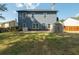 Backyard featuring an exterior shed, lawn, and view of the home's rear elevation at 170 Shoal Park Dr, Mcdonough, GA 30252