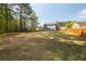 Expansive backyard with a trampoline and partial home view surrounded by mature trees at 170 Shoal Park Dr, Mcdonough, GA 30252