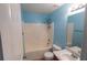 A full bathroom showing a tub with shower, toilet, vanity with sink and bright blue walls at 170 Shoal Park Dr, Mcdonough, GA 30252