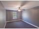 Cozy bedroom featuring gray walls, plush carpet and a ceiling fan, with natural light coming through the window at 170 Shoal Park Dr, Mcdonough, GA 30252
