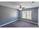 Bedroom with neutral gray walls, ceiling fan, and natural light from a large window at 170 Shoal Park Dr, Mcdonough, GA 30252