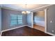 Dining room with hard wood floors, window and decorative chandelier at 170 Shoal Park Dr, Mcdonough, GA 30252