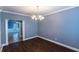 Charming dining room with hard wood floors and view into the tiled hallway at 170 Shoal Park Dr, Mcdonough, GA 30252
