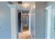 Upstairs hallway featuring neutral paint, tiled floors leading to carpeted stairs at 170 Shoal Park Dr, Mcdonough, GA 30252