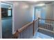 Second-floor hallway with wood banister leading to bedrooms at 170 Shoal Park Dr, Mcdonough, GA 30252