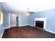 Living room boasts hardwood floors, a fireplace and an entry way to another room at 170 Shoal Park Dr, Mcdonough, GA 30252