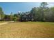 Exterior view showing a two-story home with a large front yard bordered by trees at 170 Shoal Park Dr, Mcdonough, GA 30252