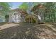 Exterior shot of a home with a spacious backyard featuring a wooden deck with stairs at 455 Tyson Cir, Roswell, GA 30076