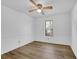 Well-lit bedroom with wood-look flooring, a ceiling fan, and a window for natural light at 455 Tyson Cir, Roswell, GA 30076
