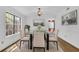 Dining room area with hardwood floors, white walls, and modern lighting fixtures at 455 Tyson Cir, Roswell, GA 30076