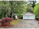 Charming home with a two-car garage and a well-maintained front yard with mature trees and nice landscaping at 455 Tyson Cir, Roswell, GA 30076