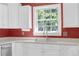Close-up of a kitchen sink with white cabinets and an exterior view from the window at 455 Tyson Cir, Roswell, GA 30076