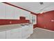 Charming kitchen featuring red walls, white appliances, and lots of cabinet space at 455 Tyson Cir, Roswell, GA 30076