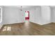 Bright living room with hardwood floors, white walls, and a decorative light fixture at 455 Tyson Cir, Roswell, GA 30076