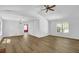 Spacious living room featuring hardwood floors, a ceiling fan, white walls, and many windows at 455 Tyson Cir, Roswell, GA 30076