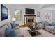 Bright living room featuring hardwood floors, a fireplace, stylish decor, and natural light at 455 Tyson Cir, Roswell, GA 30076
