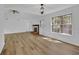 Spacious living room with a brick fireplace, ceiling fan, and large windows for natural light at 455 Tyson Cir, Roswell, GA 30076