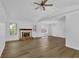 Bright living room with hardwood floors, a fireplace, neutral walls, and many windows at 455 Tyson Cir, Roswell, GA 30076
