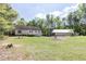 Expansive backyard features a well-maintained lawn, a detached garage, and mature trees providing privacy at 4960 Old Yorkville Rd, Dallas, GA 30157