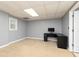 Finished basement space featuring neutral carpet, gray walls, a work station, and natural light at 4960 Old Yorkville Rd, Dallas, GA 30157
