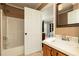Bathroom with a tub-shower combo, single sink vanity and a glimpse into the bedroom at 4960 Old Yorkville Rd, Dallas, GA 30157