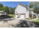 View of home's rear exterior featuring a 2-car garage, basketball hoop, covered patio, and additional garage at 4960 Old Yorkville Rd, Dallas, GA 30157