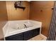 Cozy bathroom with a jetted tub, complemented by dark wood accents and textured gold walls at 4960 Old Yorkville Rd, Dallas, GA 30157
