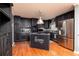 Stylish kitchen with stainless steel appliances, black cabinetry, and wood floors at 4960 Old Yorkville Rd, Dallas, GA 30157