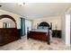 Bedroom with a king-sized bed, dark furniture, tile floor, and an en-suite bathroom at 4960 Old Yorkville Rd, Dallas, GA 30157
