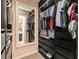 Organized walk-in closet with shelving, drawers, hanging racks, and a decorative mirror at 4960 Old Yorkville Rd, Dallas, GA 30157