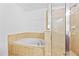 Bathroom features a soaking tub and a glass-enclosed shower, with tiled walls and floors at 2116 Gorman Se Grv, Atlanta, GA 30316