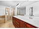 Bathroom featuring double sinks with a large mirror, tiled floors, and a glass-enclosed shower at 2116 Gorman Se Grv, Atlanta, GA 30316