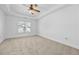 Spacious bedroom features plush carpet, a ceiling fan and a large window at 2116 Gorman Se Grv, Atlanta, GA 30316