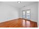 Neutral bedroom with hardwood floors and glass doors with access to an outdoor space at 2116 Gorman Se Grv, Atlanta, GA 30316