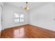 Sunlit bedroom with hardwood floors, a modern light fixture and a large window at 2116 Gorman Se Grv, Atlanta, GA 30316