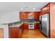 Charming kitchen featuring stainless steel appliances, rich wood cabinets and hardwood flooring at 2116 Gorman Se Grv, Atlanta, GA 30316