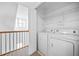 Convenient laundry room featuring a washer and dryer, with shelving for storage at 2116 Gorman Se Grv, Atlanta, GA 30316