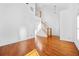 Open-concept living area showcasing high ceilings, hardwood floors, and a staircase with wooden railings at 2116 Gorman Se Grv, Atlanta, GA 30316