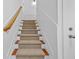 Carpeted staircase with white risers and a wooden handrail leading to the upper floor at 2116 Gorman Se Grv, Atlanta, GA 30316