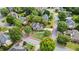 Aerial view showcases a home with mature trees, landscaping, and well-manicured lawn in a suburban neighborhood at 295 Sagamore Nw Cv, Sugar Hill, GA 30518