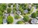 An aerial view highlights a lovely neighborhood with homes surrounded by mature trees and manicured lawns at 295 Sagamore Nw Cv, Sugar Hill, GA 30518