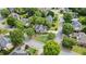 Stunning aerial view of a home on a corner lot surrounded by lush landscaping and mature trees at 295 Sagamore Nw Cv, Sugar Hill, GA 30518
